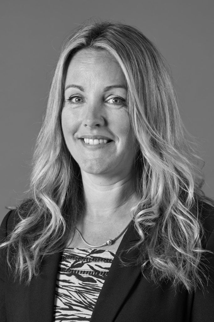 Professional studio headshot against a neutral background